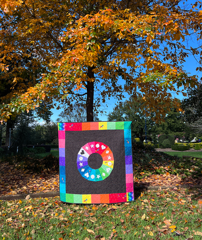 Daydream quilt pattern featuring a colour wheel and geometric shapes sewn in fabric