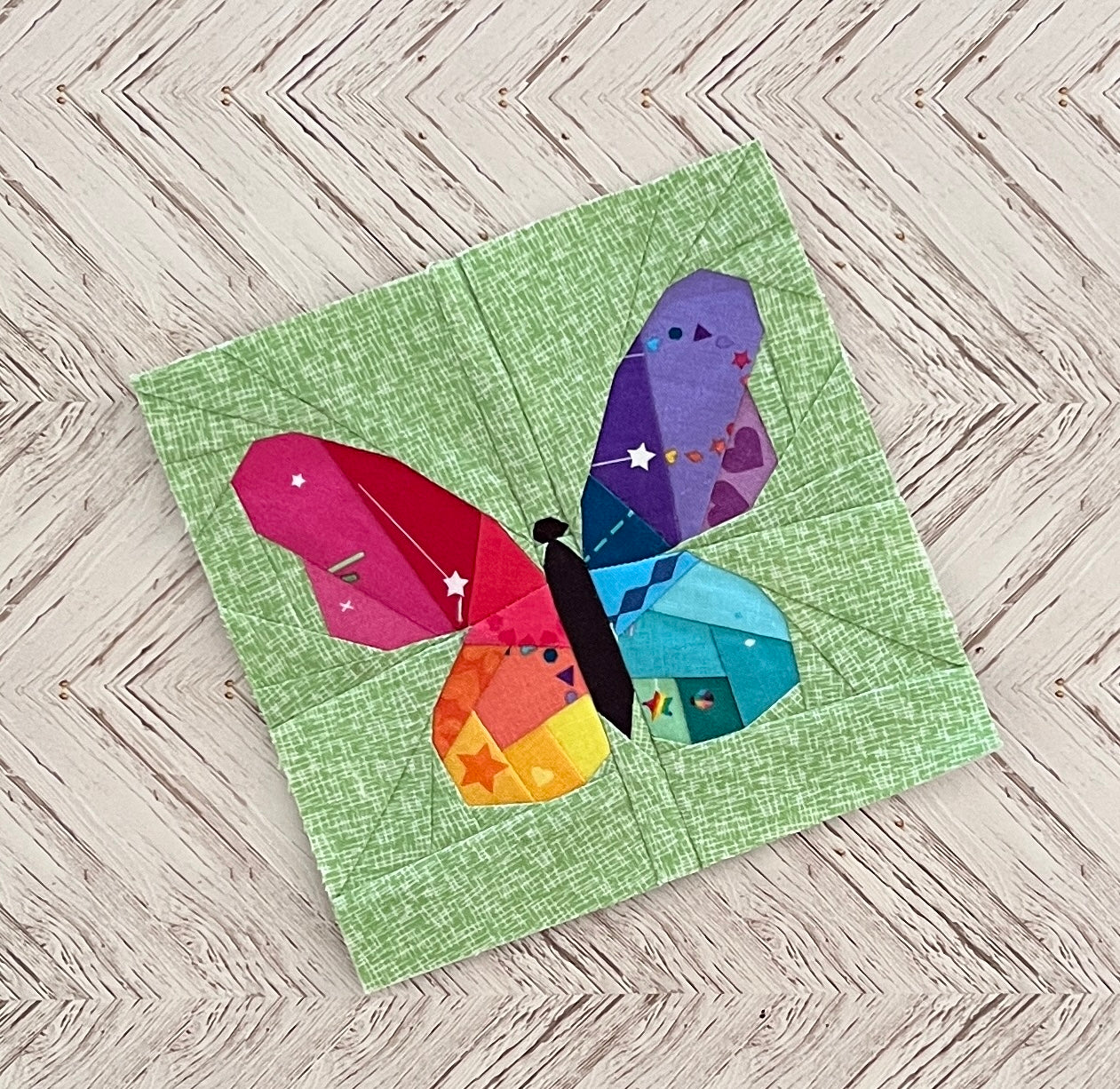 flutter geometric butterfly paper pieced pattern in rainbow sewn in fabric