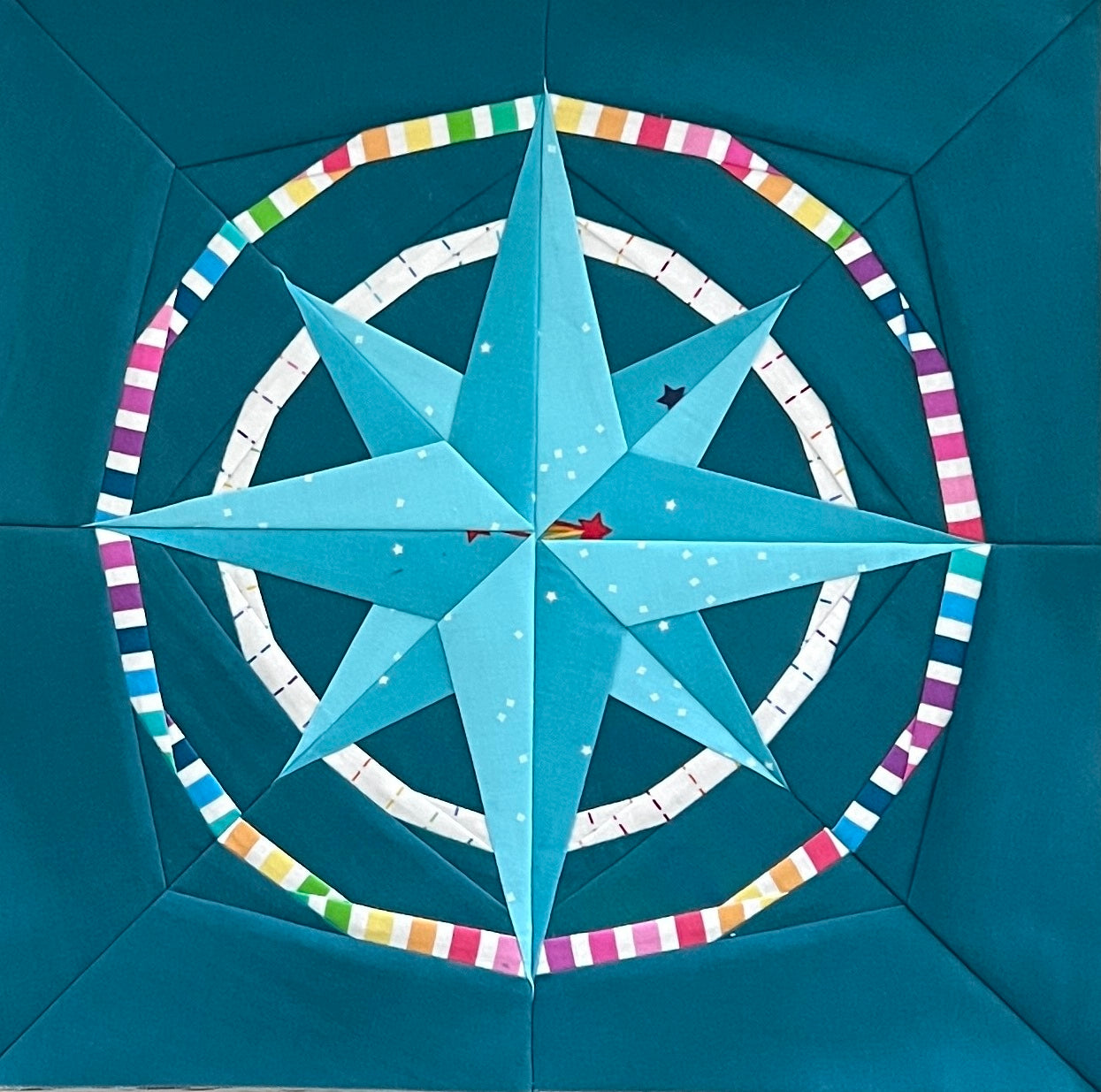 nautical mariner's compass paper pieced pattern sewn in rainbow fabric