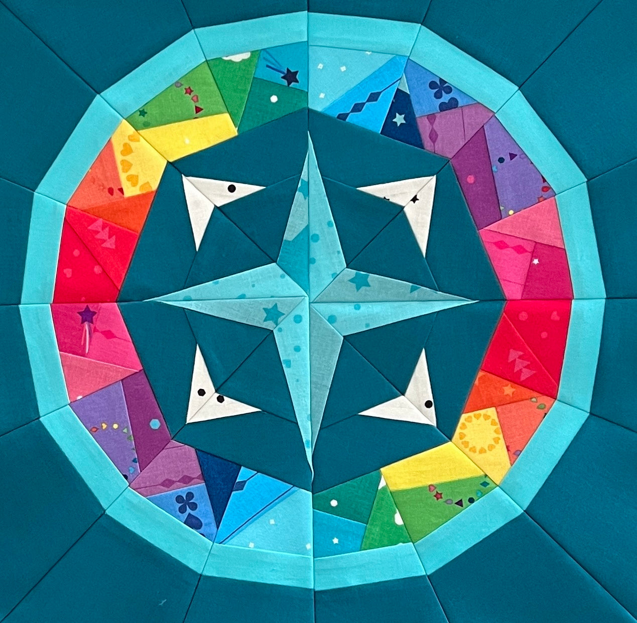 oceanic compass paper pieced pattern sewn in rainbow fabric