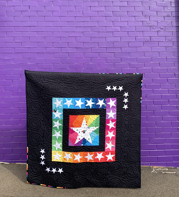 starlight paper pieced quilt pattern featuring rainbow stars