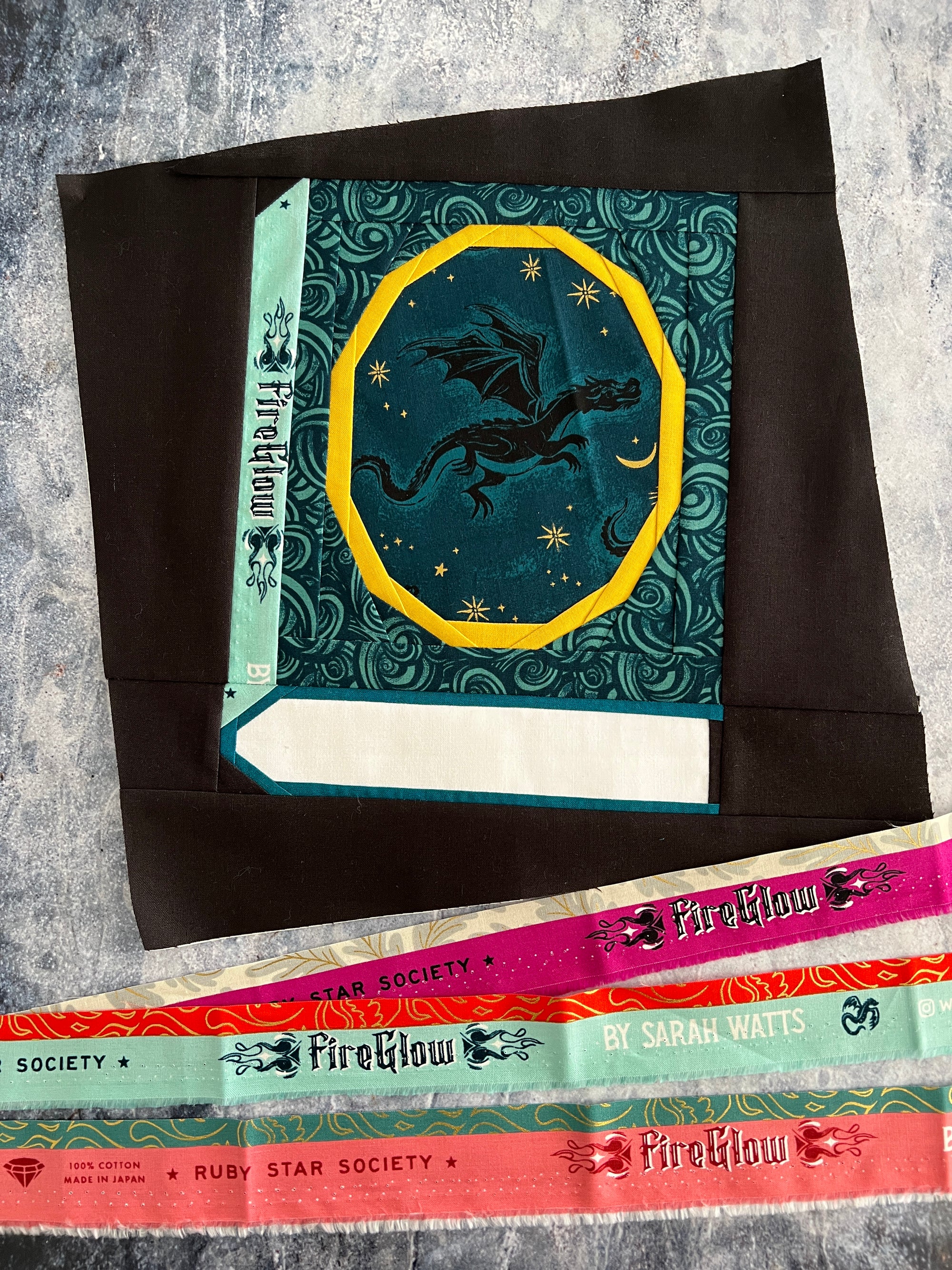 A foundation paper pieced Book block featuring an oval frame for a fussycut fabric feature