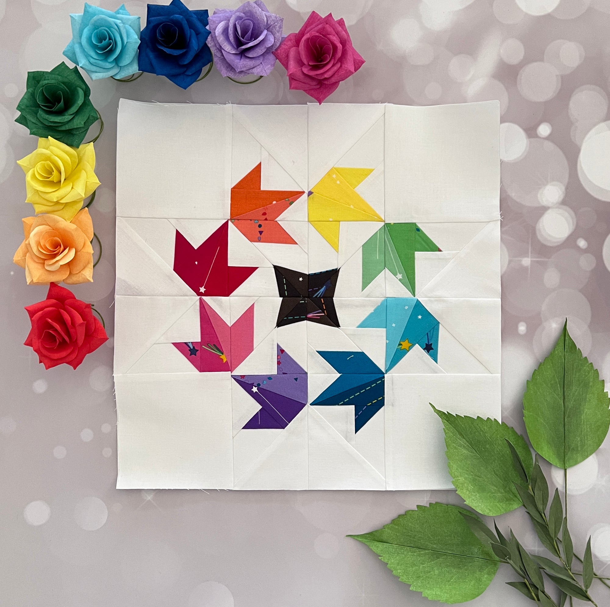 glimmer paper pieced pattern sewn in rainbow fabrics