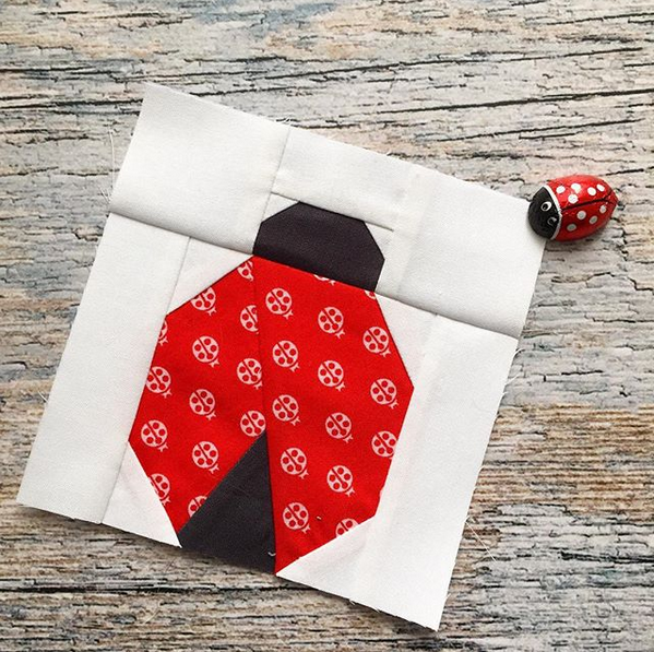 paper pieced ladybug sewn in red fabrics