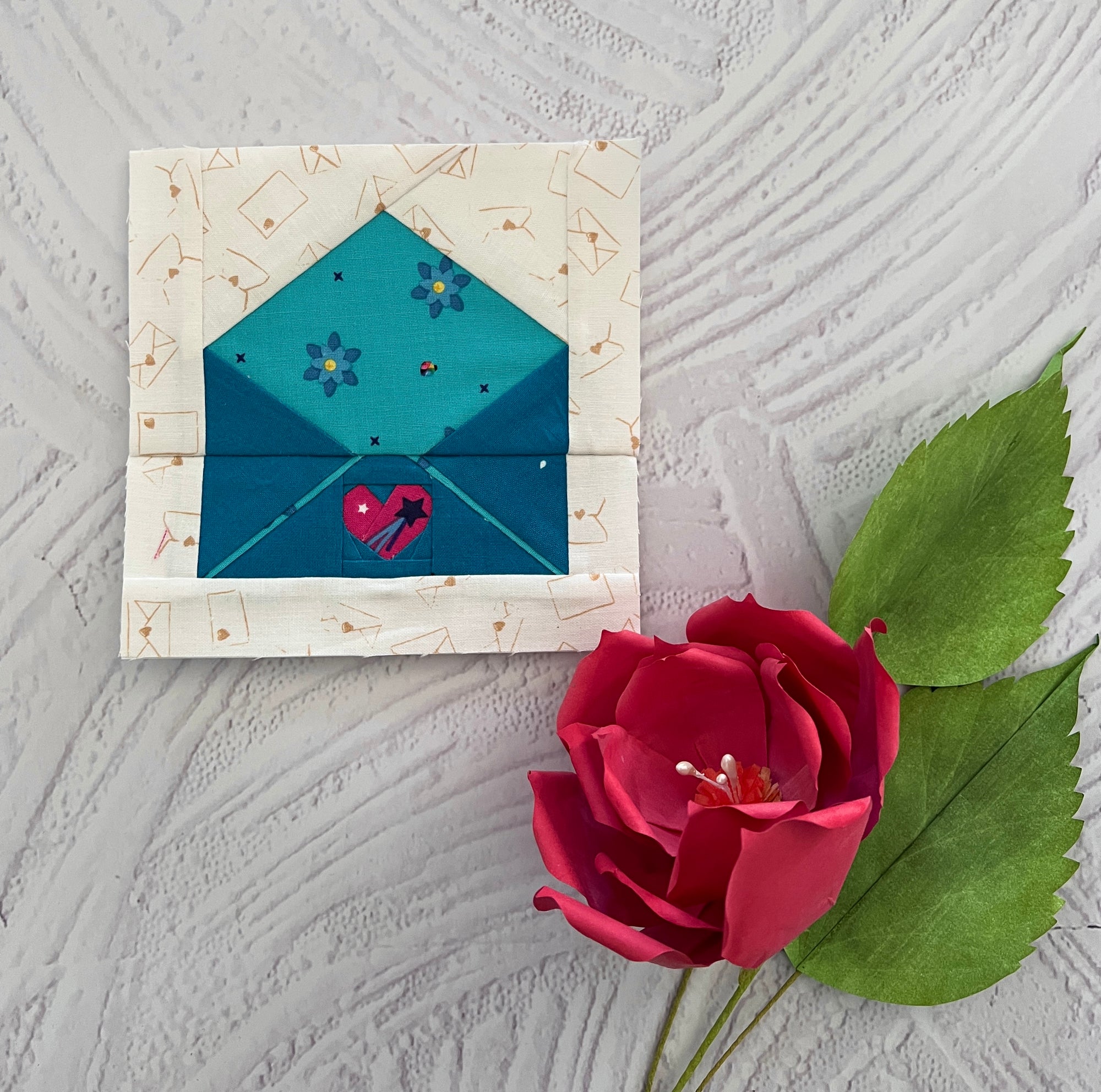 Finished foundation paper pieced envelope quilt block shown in fabric with heart seal detail. A romantic FPP pattern that adds a thoughtful touch to quilts, wall hangings, and handmade gifts.