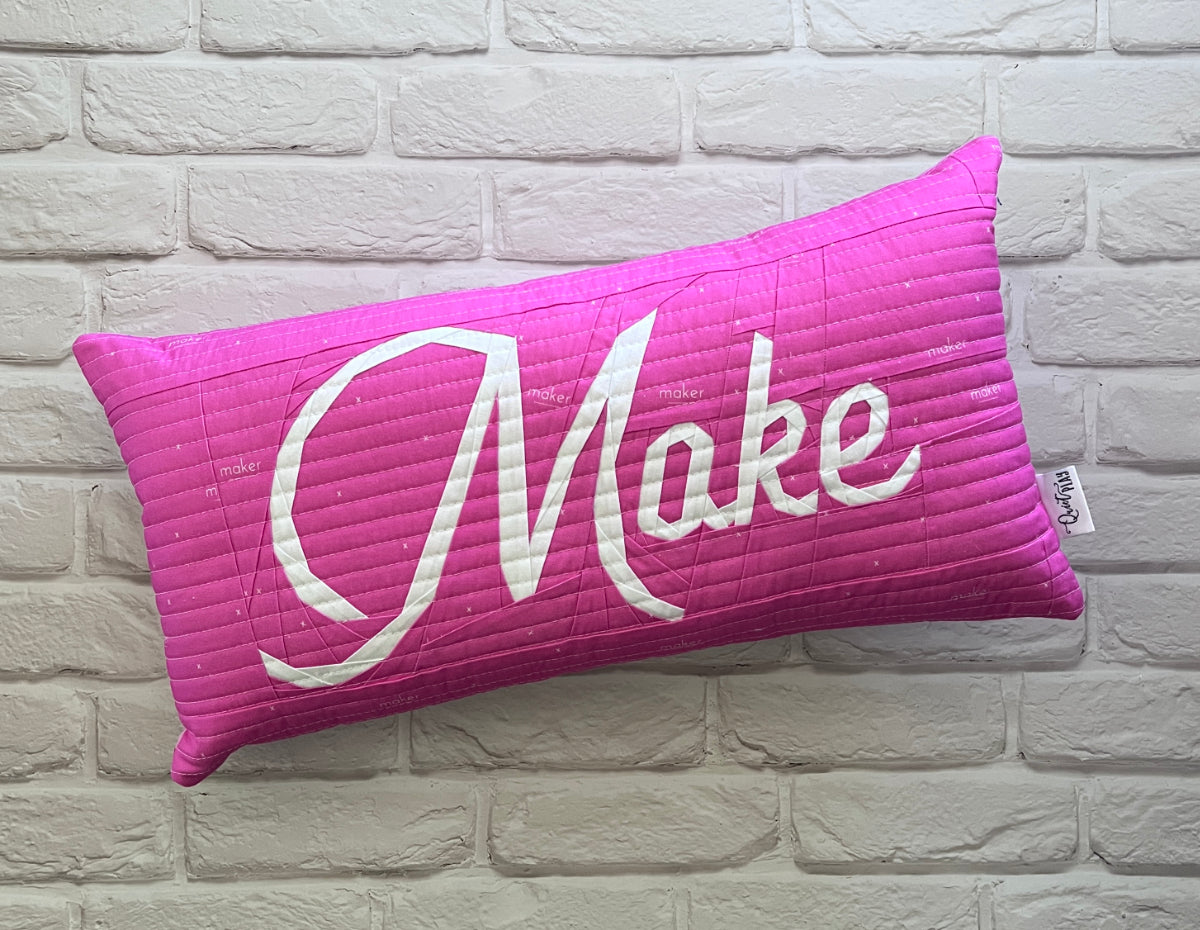 make in script paper pieced pattern sewn into a pillow