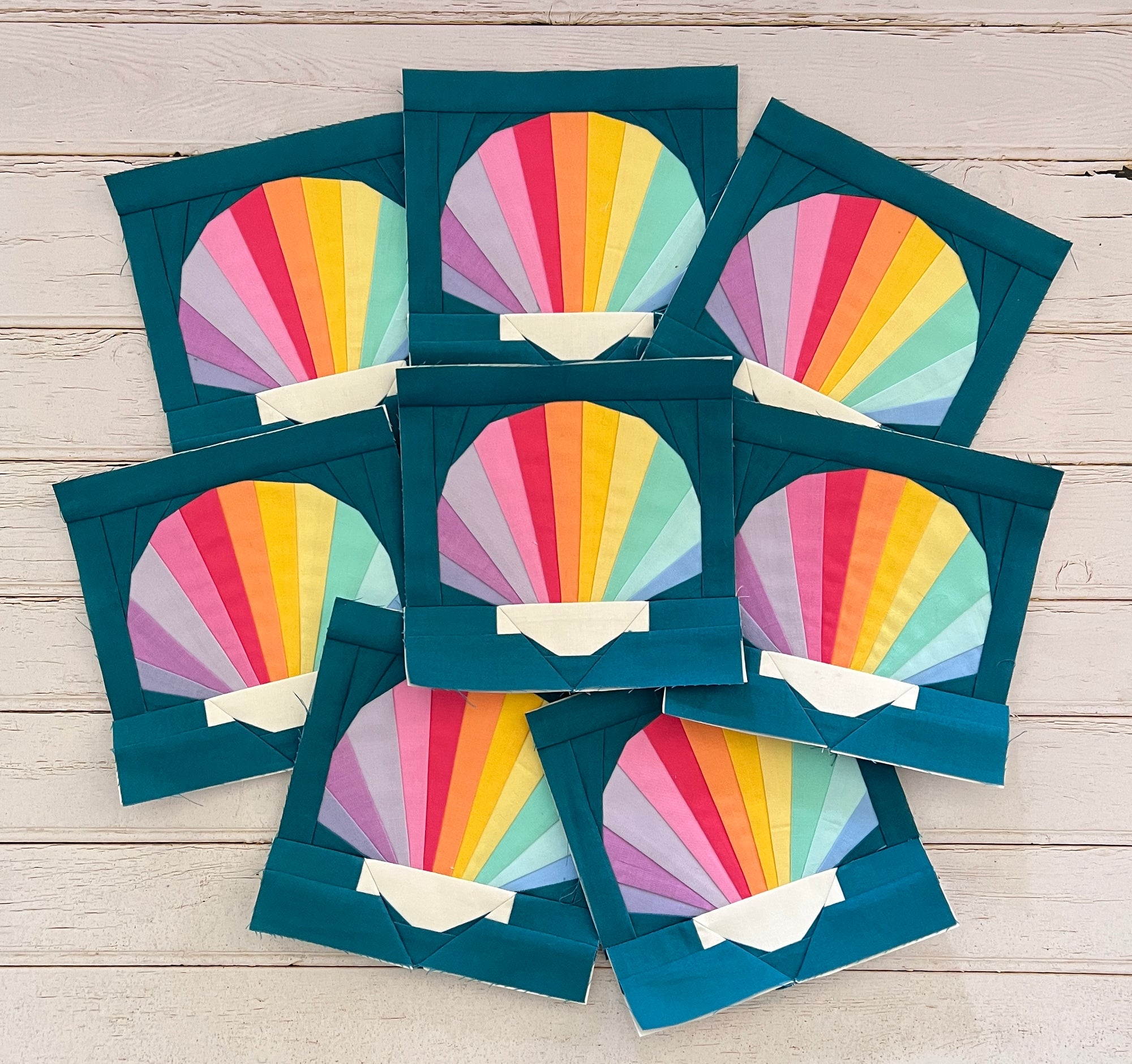 scallop shell paper pieced pattern sewn in rainbow fabric