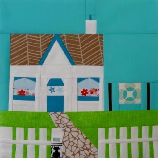 a quilters cottage foundation paper pieced pattern with a little cottage, picket fence and a quilt on the washing line