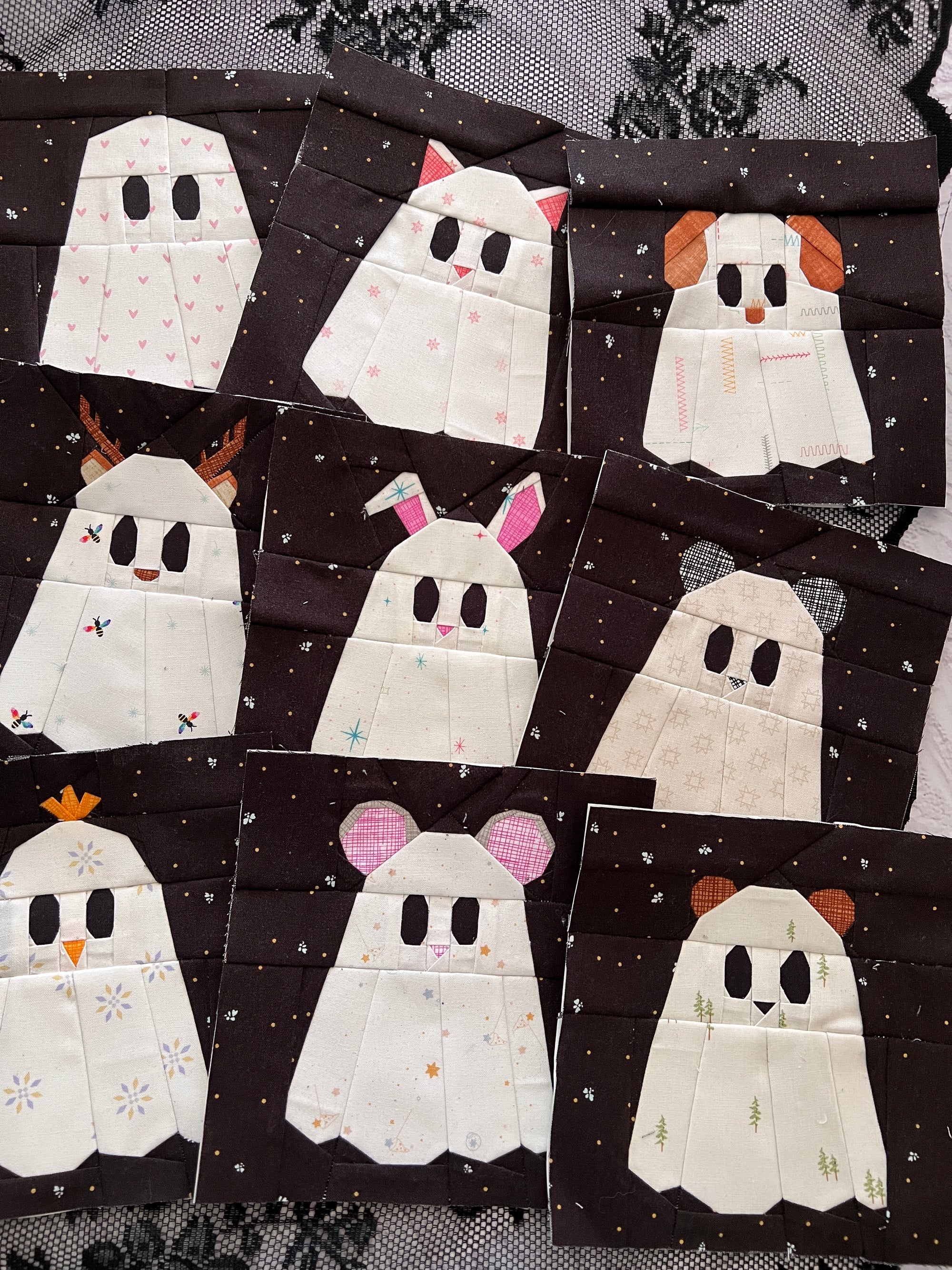 Foundation paper pieced ghost animal quilt blocks arranged together as a Boo Crew bundle
