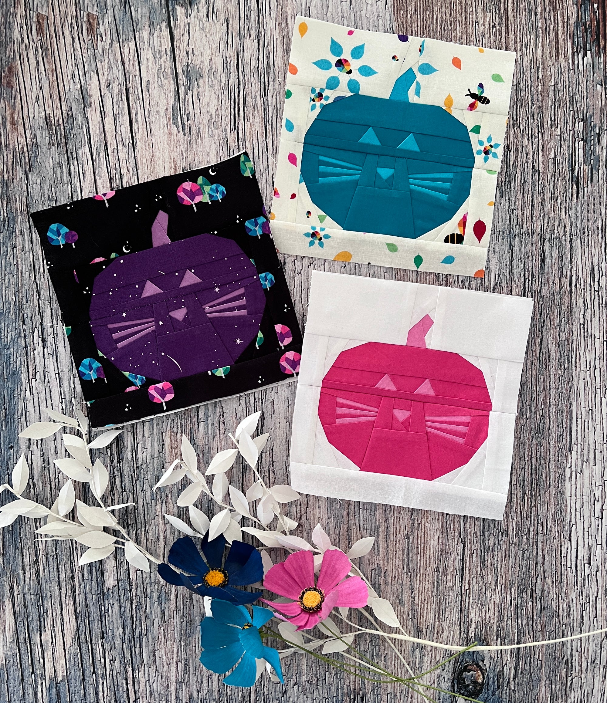 Finished Cat O Lantern foundation paper pieced quilt blocks styled on a wooden surface