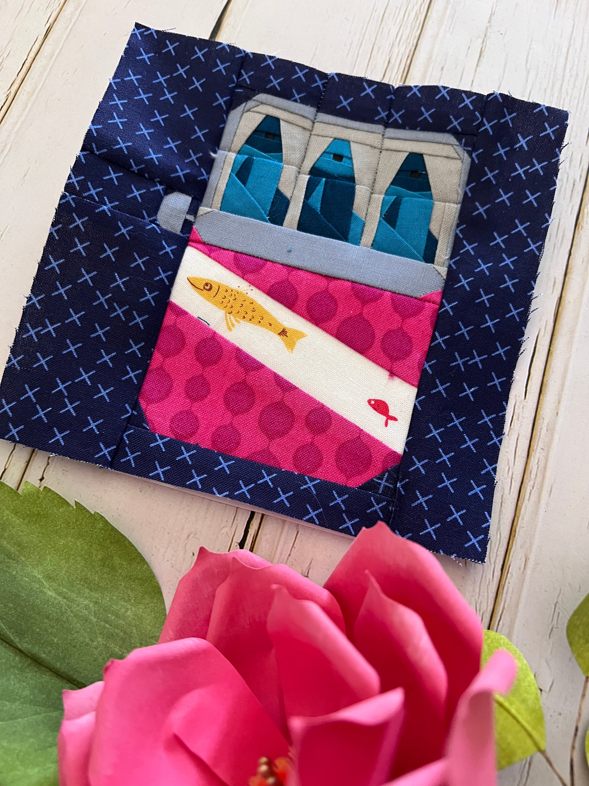 Finished sardine tin paper pieced quilt block photographed as a sewn fabric sample