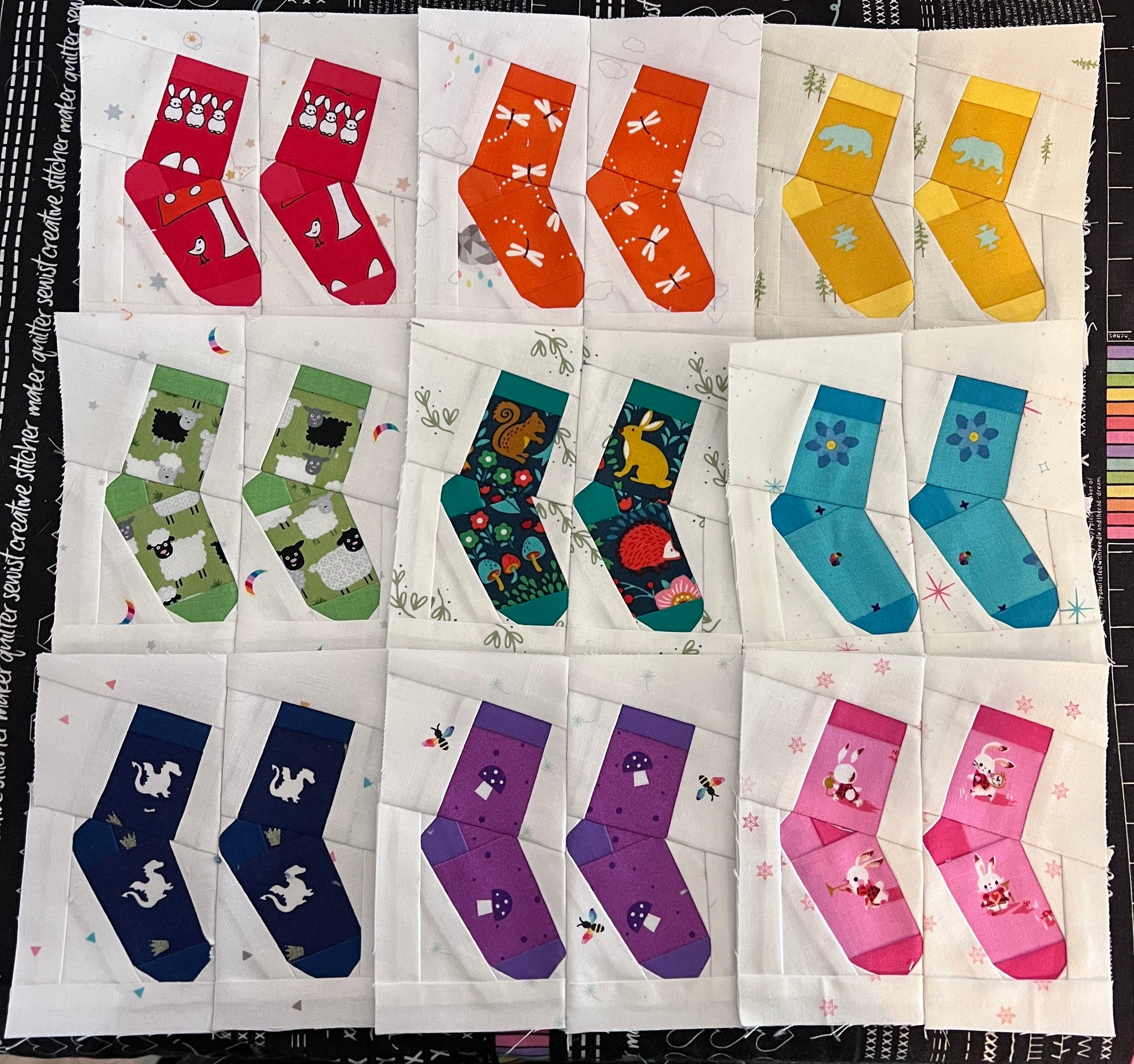 Multiple silly socks quilt blocks in different fabric colours