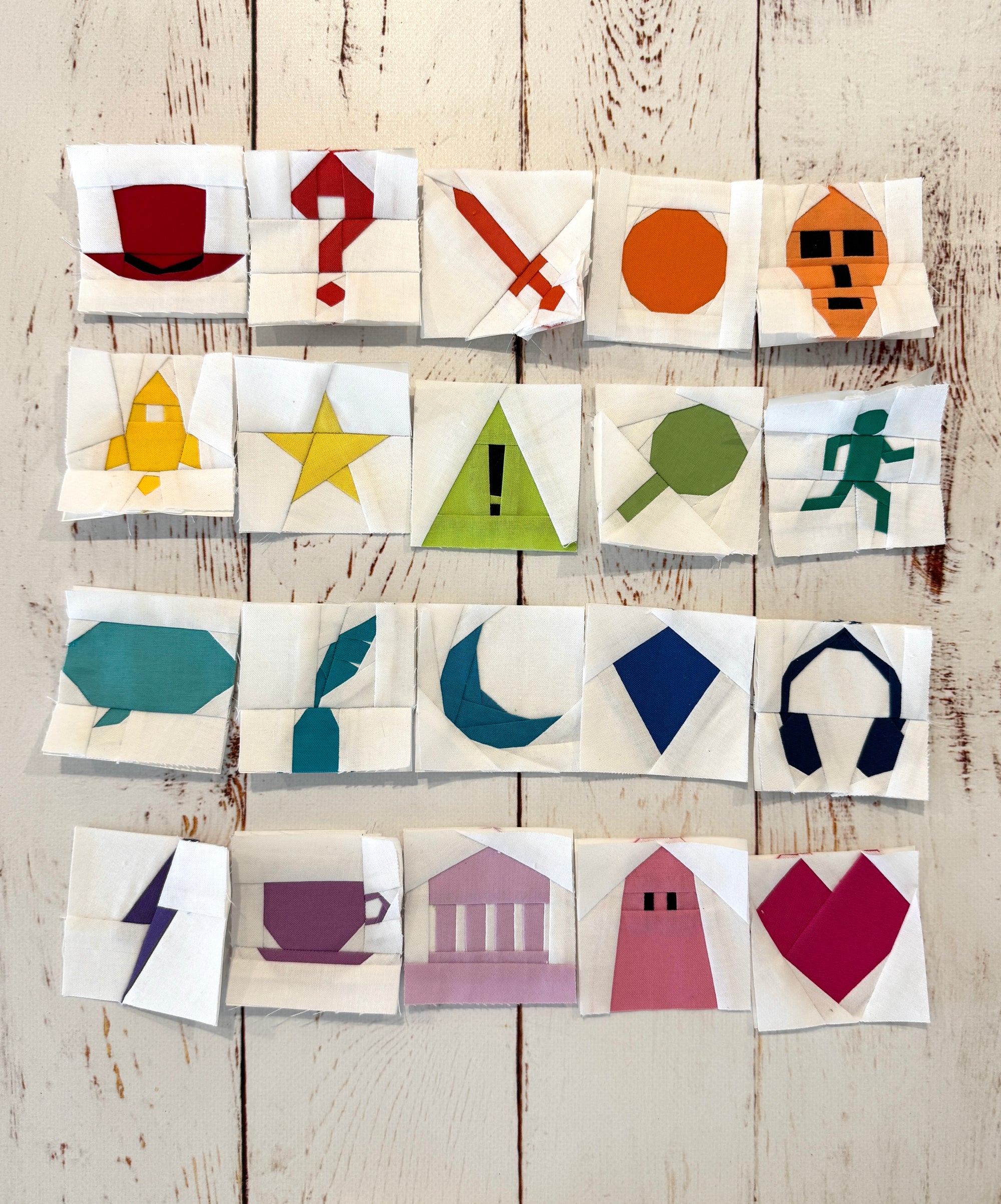 Foundation paper pieced genre icon blocks included in The Library quilting pattern showing book symbols and reading themes