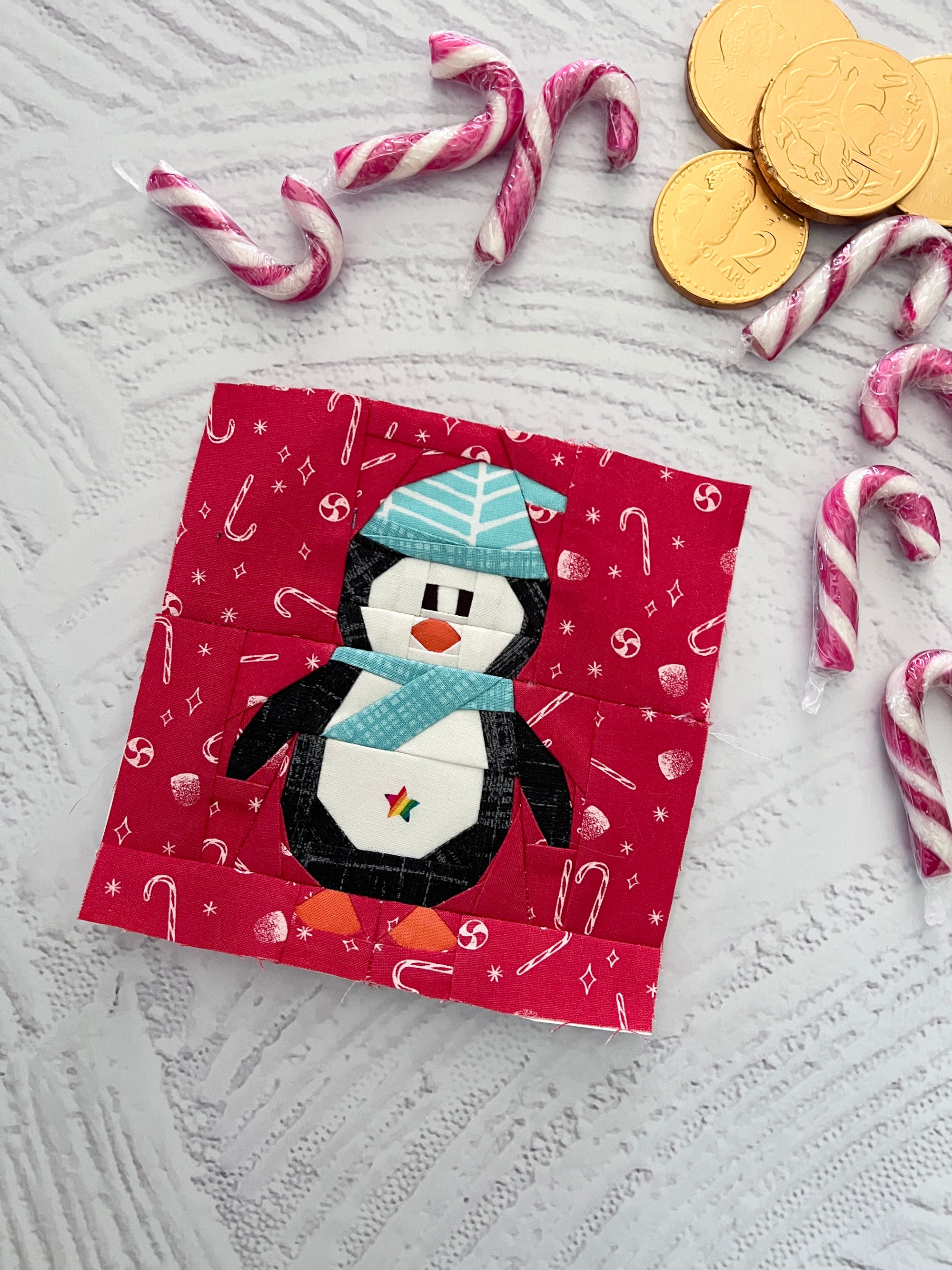 Finished winter penguin foundation paper pieced quilting pattern sewn into a quilt block with winter fabric